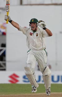 South Africa captain Graeme Smith celebrates on completing his century during the opening day of the fourth and final Test against the West Indies in St Johns, Antigua, on Friday