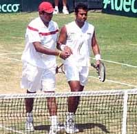 Leander Paes  and Mahesh Bhupathi congratulate each other after beating Uzbekistans Denis Istomin and Murad Inoyatov in the Davis Cup Asia-Oceania second round doubles match at the Jai Club in Jaipur on Saturday