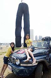 South Korean models pose in front of a huge blue jeans in Seoul on Sunday. The jeans with a height of 30 metres is recorded in the Guinness Book of Records as the largest blue jeans in the world. 