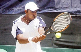 Indias Prakash Amritraj hits a return shot to Farrok Dustov of Uzbekistan during their reverse singles Davis Cup Asia-Oceania match in Jaipur on Sunday. Prakash won 6-7 (4-7), 6-4, 6-2. 
