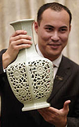 A Sothebys employee displays a rare Qing Dynasty vase during a press preview in Hong Kong on Monday. The vase of the Qianlong period fetched HK $ 44.9 million ($ 5.7 million) setting a new world record for Qing porcelain. 