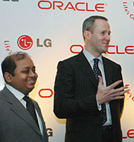 The Senior Vice-President Application, Oracle Corporation, Asia-Pacific Division, Mark Gibbs (R), gestures while addressing a press conference as Head of IT Systems, LG Electronics India Private Limited Arindam Bose (L) looks on, in New Delhi, on Monday.
