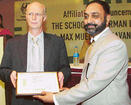 Dr Stefan Dreyer (left), South Asian Regional Director, Goethe Institute, Max Mueller Bhavan, Delhi, presents the affiliation certificate to Mr Surinder Singh Maaken (right), founder of the School of German Languages at a function in Chandigarh on Monday. 