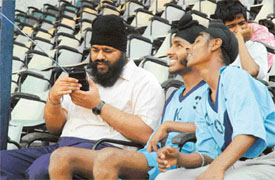 Visually impaired participants have some time off to hear the transistor during the 2nd North Zone Athletic Meet in Ludhiana on Monday