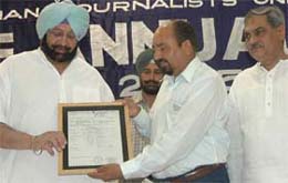 Punjab Chief Minister, Capt Amarinder Singh, releasing an insurance policy certificate for scribes