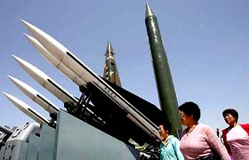 South Korean women walk by a model of a Scud-B missile at a war museum in Seoul on Monday