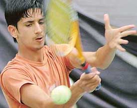 Parul Verma of Chandigarh plays a shot against Pulkit from Delhi in under-16 AITA Super-series Tennis Tournament in Chandigarh on Tuesday