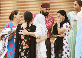Relatives of Navdeep Kaur cry outside her in-laws house in Karnail Singh Nagar in Ludhiana on Tuesday