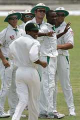 South Africa fast bowler Monde Zondeki  is congratulated by teammates after taking the wicket of West Indies batsman Brian Lara