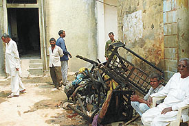 People outside a house in Mehrauli where two members of a family were burnt to death due to short-circuit in the Capital on Wednesday