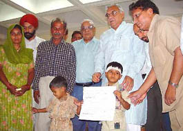 The Haryana Chief Minister, Mr Bhupinder Singh Hooda, blesses master Akash and master Sahil, sons of  late Roop Basant Bachchan, a journalist, at a function in Chandigarh on Wednesday.  On the left of Mr Hooda is the Editor-in-Chief of The Tribune group of newspapers, Mr H.K. Dua.
