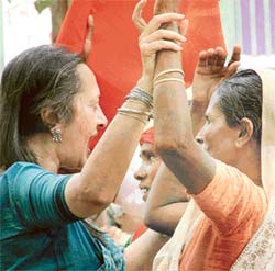 CPM Politburo member Brinda Karat dances with women who had come from different parts of the country to participate in a rally