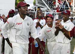 West Indies' Chris Gayle (left) is greeted by teammates after being named Man of the Match at the end of the final Test against South Africa in St. John's, Antigua, Tuesday. 