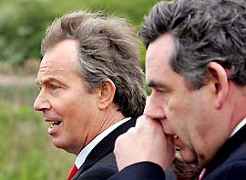 Britain's Prime Minister Tony Blair and Chancellor of the Exchequer Gordon Brown walk through Elstree Aerodrome near London on the last day of the election campaign on Wednesday
