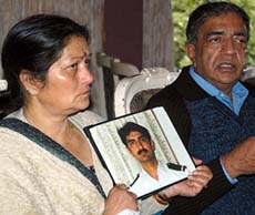 Parents of naval engineer, Tarun Sharma, who died under mysterious circumstances in the UAE, with the photo of their son, at a press conference in Shimla on Thursday. 