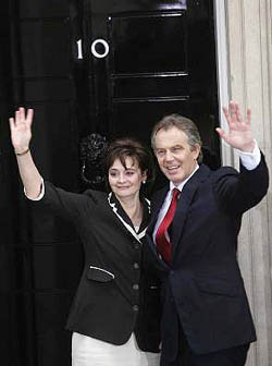 Britain's Prime Minister Tony Blair and his wife Cherie return to London's 10 Downing Street, early on Friday. Blair won a historic third term as Prime Minister, but his Labour Party suffered a sharply reduced parliamentary majority.