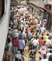The crowd that had gathered outside the house of moneylender Bachan Singh who was robbed and seriously wounded in this street with his son and daughter by four armed robbers at Muradpura colony near Gill road