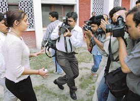 Photographers try to capture former Miss Jammu Anara Gupta as she leaves after a meeting with CPM Politburo member Brinda Karat in New Delhi on Thursday.