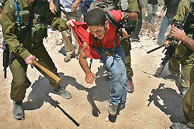 An Israeli protester screams after being beaten by an Israeli soldier during a joint demonstration with Israelis and Palestinians against Israels controversial barrier in the West Bank village of Bilin