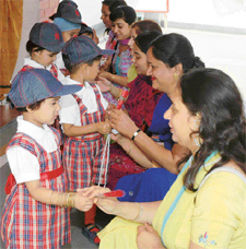 Students of Disney Land Nursery School present roses to mothers at a function on Saturday