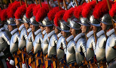The thirty new recruits of the Vatican's elite Swiss Guard stand at attention during a swearing-in ceremony in Saint Damaso courtyard at the Vatican on Friday