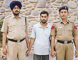A member of O. P. Saini gang, Brij Mohan, alias Guddu, in police custody after he was arrested in Chandigarh on Sunday