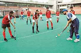 Budding hockey players getting tips from coach Jasbir Singh Bajwa during a practice session at the Sports Complex, Sector 42, Chandigarh
