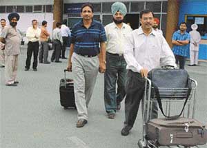 Passengers who took the inaugural flight of Air Deccan from New Delhi to Chandigarh come out of the Chandigarh Airport, near here, on Monday morning.