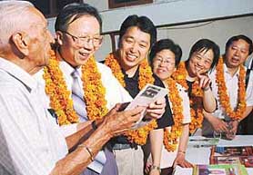 Major Jeevan Tewari (retd) shows journals to Chinese delegation at a function in Panjab University, Chandigarh, on Monday.