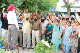 Milk Plant employees hold a rally outside the plant on Ferozepore Road in Ludhiana on Monday