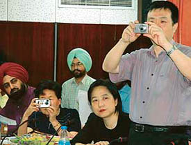 Chinese delegates focus their cameras on city photographers (not in picture) during a seminar on education at the UT Guest House in Chandigarh on Tuesday. 