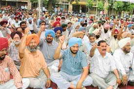 Teaching and non-teaching employees of the Punjab Agricultural University protest on the campus against the bifurcation of the university in Ludhiana