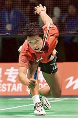 Olympic champion Taufik Hidayat of Indonesia reaches for a shot during his mens singles match against Ng Wei of Hong Kong at the Sudirman Cup championship in Beijing on Tuesday