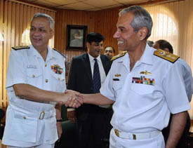 Real Admiral Ahsan-ul-Haq (right), Additional Secretary in Pakistans Ministry of Defence, greets Vice-Admiral Arun Kumar Singh (left), Director-General of the Coast Guard, in Rawalpindi on Tuesday.