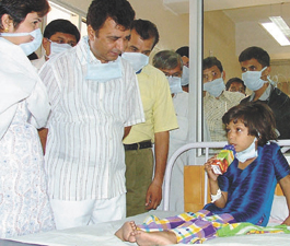 MCD Health Committee Chairman Ramesh Pandit speaking to a patient of bacterial meningitis at Bara Hindu Rao Hospital in the Capital.