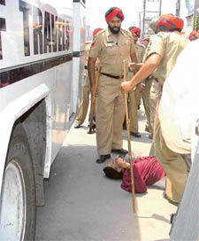 Prof Jagmohan Singh Tonny, Secretary, Shiromani Akali Dal Amritsar, lies on the ground after being allegedly manhandled by the police outside a cinema house in Ludhiana on Friday