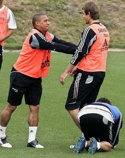 England's Real Madrid player David Beckham is pushed by his Brazilian teammate Roberto Carlos