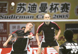 Anthony Clark of Great Britain plays a shot as his partner Robert Blair looks on during their mens doubles match against Liu Kwok Wa and Albertus Susanto Njoto of Hong Kong at the Sudirman Cup in Beijing on Friday