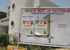 Politicians find an easy way of giving message by pasting posters on sector guide maps