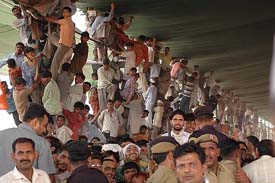 To have a glimpse of Congress President Sonia Gandhi, people climb on the bamboo poles holding the shamiana at the Dhanyavad Rally in Jind on Saturday