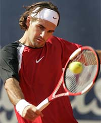 Roger Federer of Switzerland returns a ball to Guillermo Coria of Argentina