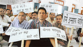 Members of Shri Atmanand Jain Sabha hold a protest against the deletion of votes, in Ludhiana