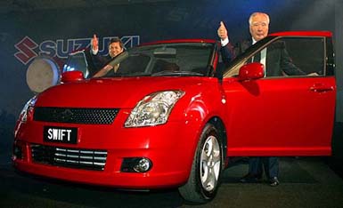 Mr Osamu Suzuki, Chairman and CEO of Suzuki Motor Corp. (right) and Mohd Salleh Sulong, Chairman of DRB-HICOM Berhad show thumbs-up after launching the new Suzuki Swift 1.5- litre car model in Kuala Lumpur, on Monday. It is targeted at suburban young families.
