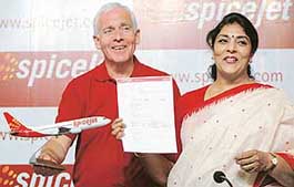 Tourism Minister Renuka Choudhary, right, shows an Internet ticket of SpiceJet as Mr Mark Winders, Chief Executive Officer of SpiceJet, looks on at the launch of SpiceJet airline services in India on Tuesday.