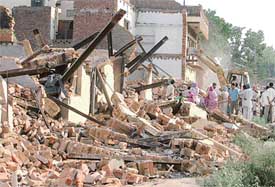 MC team demolishing structures in Giaspura area in Ludhiana on Tuesday