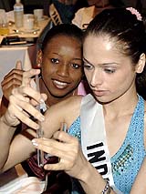 Wenieka Ewing, Miss Turks and Caicos and Amrita Thapar, Miss India, participate in an HIV\AIDS orientation presentation by the Global Health Council in Bangkok on Monday