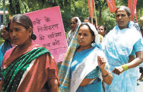 An activist of Socialist Unity Centre of India leads a march against the water tariff hike and proposed privatisation of water supply and electricity distribution in the Capital