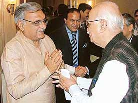 Chief Minister of Haryana Bhupinder Singh Hooda has a discussion with Leader of the Opposition and BJP National President L.K. Advani during a CII National Conference in New Delhi on Wednesday. 
