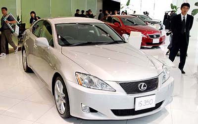 Reporters and photographers roam around Toyota Motor Corps new Lexus Takanawa at the dealerships press preview in Tokyo on Thursday