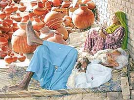 Scorching sun forces a potter couple to take a break from their gruelling routine in Sector 29, Chandigarh, on Thursday afternoon
